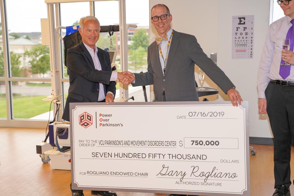 Gary Rogliano presenting check