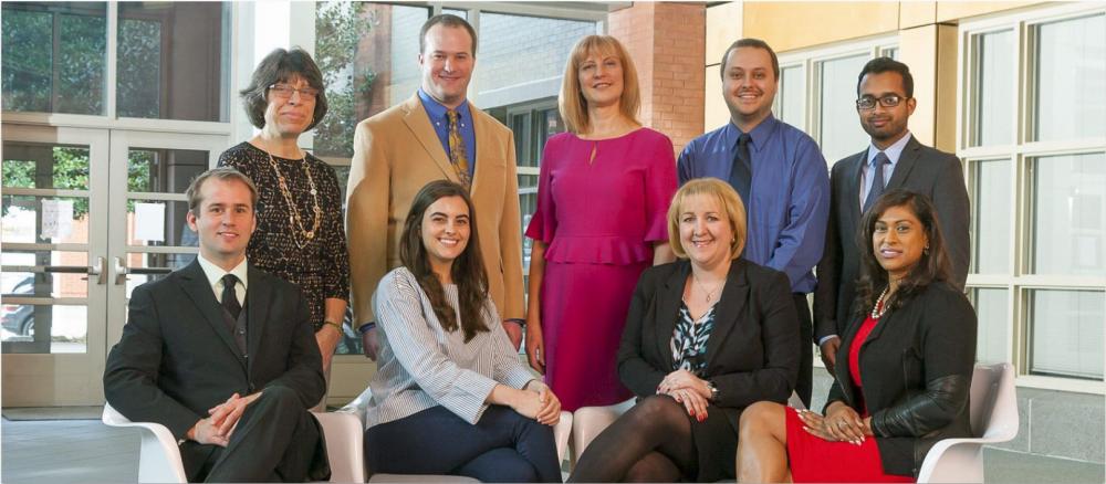 The VCU Innovation Gateway team poses in the atrium of the Biotech One building on the MCV Campus. (Back row, L to R) Ann Boelzner, accountant; Michael Mancini, Ph.D., manager of business development; Ivelina Metcheva, Ph.D., executive director; Tyler Ferro, licensing liason; and Afsar Q. Mir, licensing associate. (Front row, L to R) Brent Fagg, licensing associate; Livia Horton, intellectual property administrator; Magdalina Morgan, Ph.D., licensing associate; and Zena Singh, office manager.