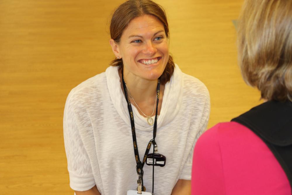 Stephanie Ross, a VCU Health N.O.W. Center physical therapist, speaks with patient Lei Robinson during a recent visit.