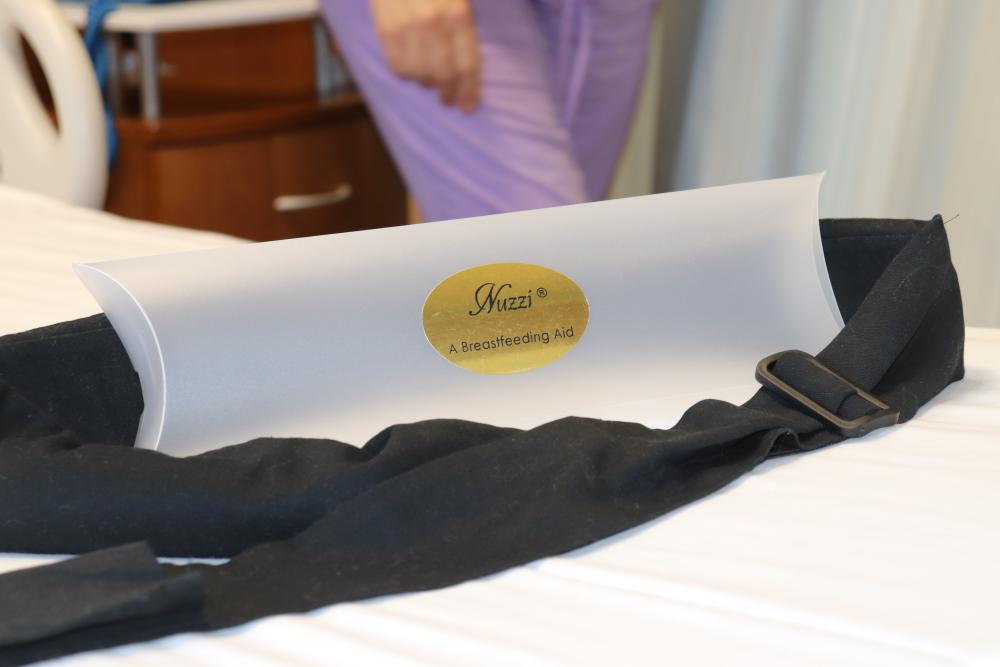 The Nuzzi sits on display with its packaging. After a clinical trial that will take about six months and likely show increased duration, comfort and overall success among participants who are breastfeeding using the device, it will be ready for public use.