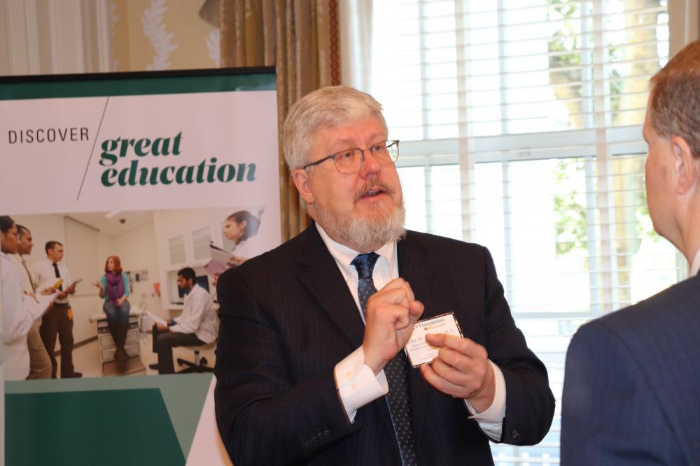 John McCarty, M.D., discusses CAR T-cell therapy with a member at our second Health Innovation Forum in May.