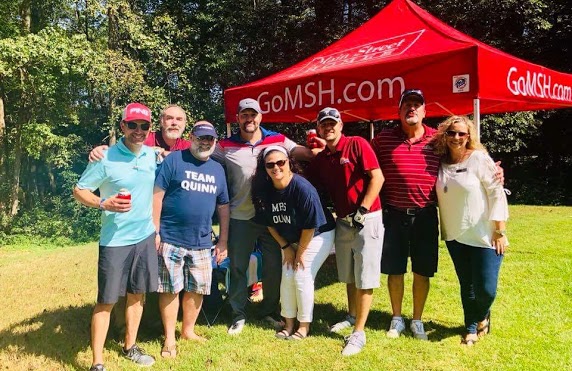 Bobby Quinn and Michele Quinn, both in the center wearing blue, enjoy the 2018 Main Street Homes Charity Golf Tournament benefitting Harper’s Hope Fund for ALS at VCU Health. Photo courtesy of Bobby Quinn