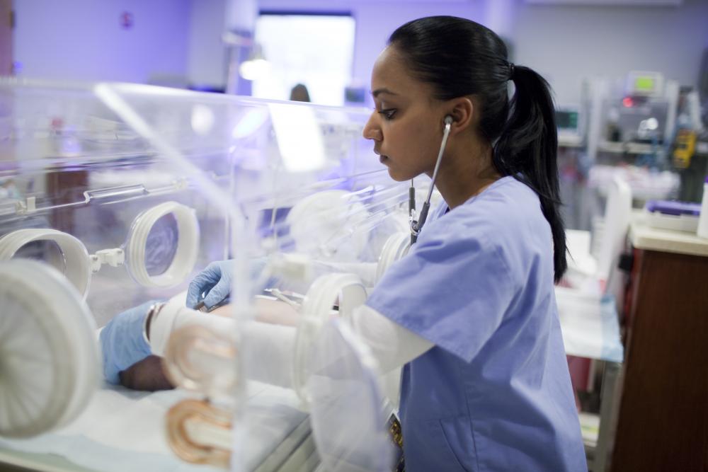 nurse listening to newborn heart