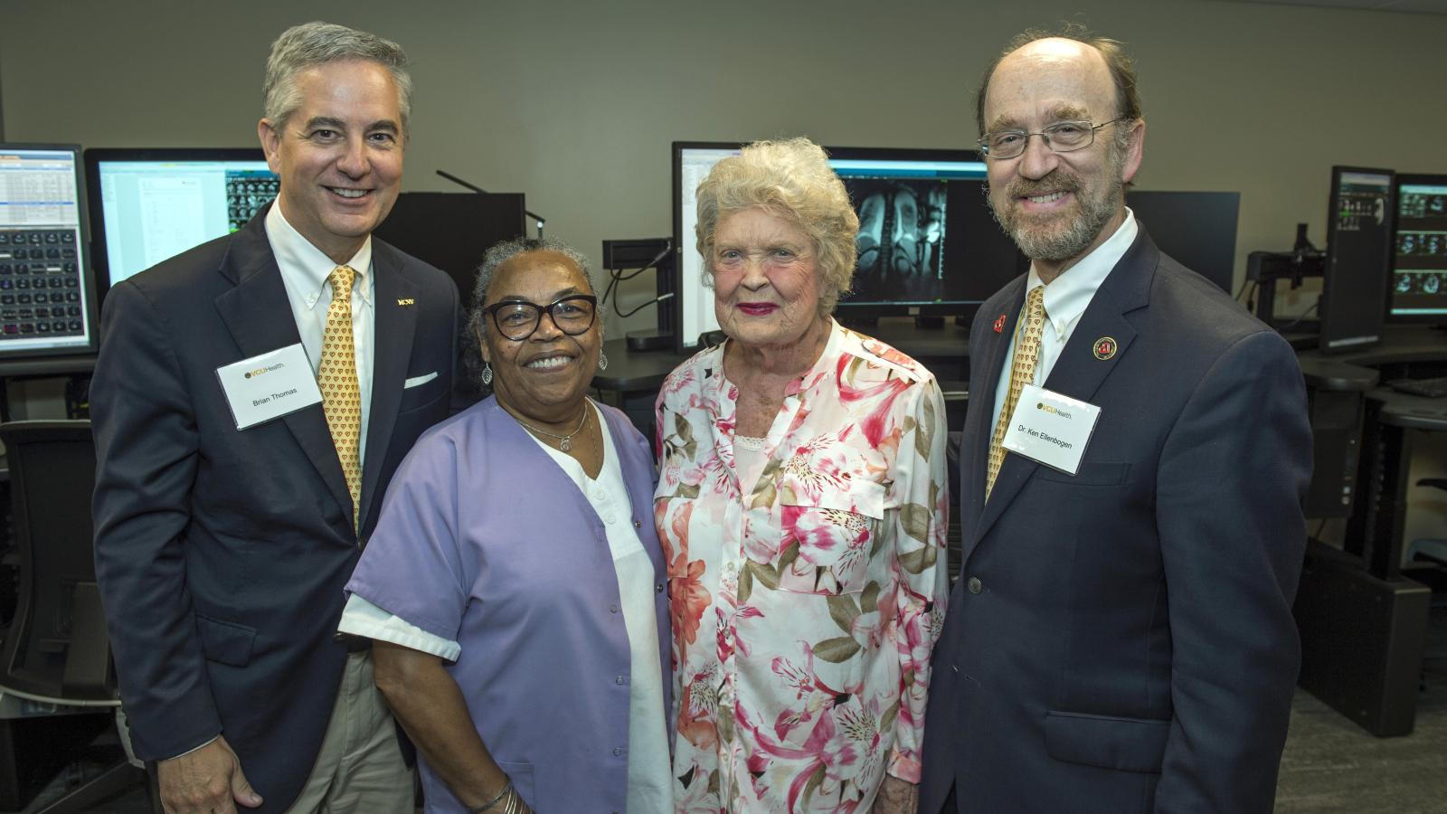 Brian Thomas, MCV Foundation vice president and chief development officer; ____getting this name from Brian now____; Barbara Clarke; and Ken Ellenbogen, M.D., chair of the Division of Cardiology, explore the room in the Cardiac Imaging Suite where images are processed and analyzed. Photo: Kevin Morley, VCU University Marketing