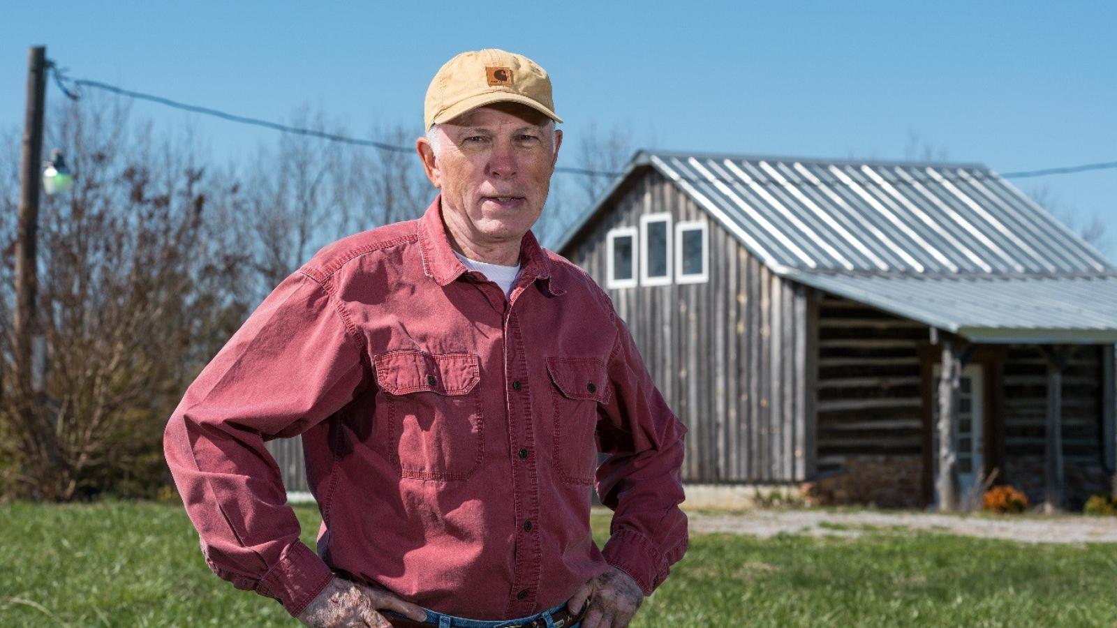 Dr. Duffer in rural Virginia. Barn in background.
