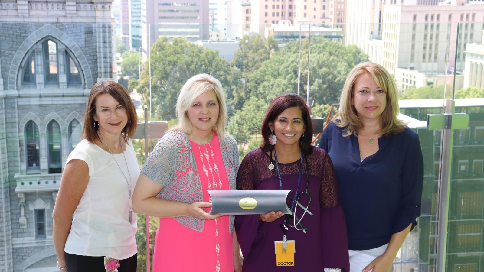 ( L to R) Lisa Rettig, Sharon Brinkley, Gauri Gulati, M.D., and Kristie Bonovitch show a show a packaged Nuzzi, which is a breastfeeding aid the four invented. Lisa, Sharon and Kristie are nurses in VCU Health’s Mother-Infant Unit and Gauri is assistant professor of pediatrics.​​​​​​​