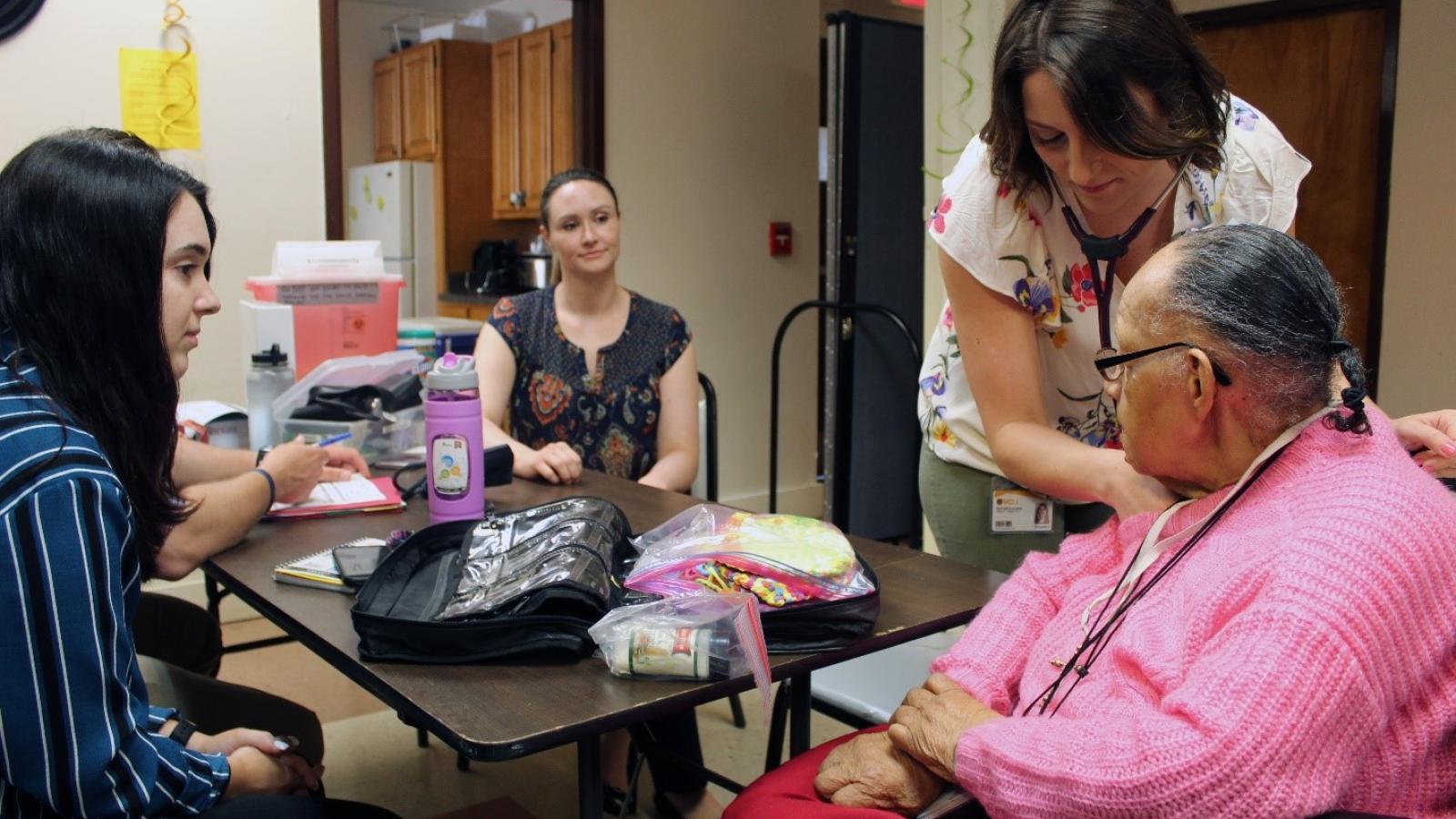A nurse practitioner student examines a resident at one of the VCU School of Nursing’s Richmond Health and Wellness Program sites. Scholarships for students keep a world-class education within reach for aspiring nurse practitioners. Photo Courtesy of VCU School of Nursing