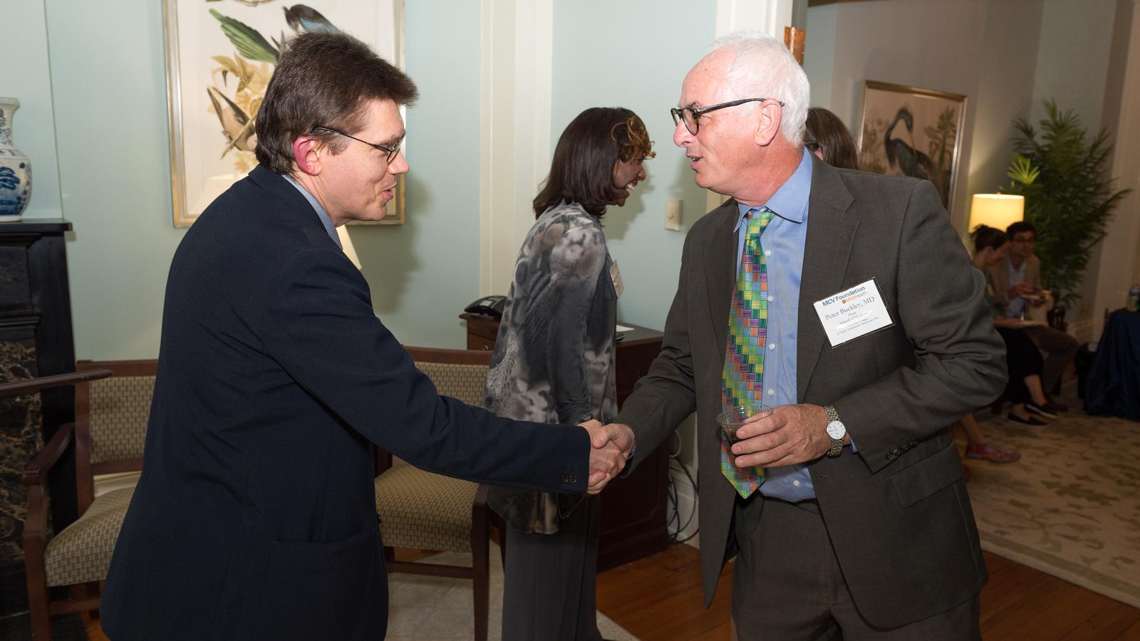 Blick Scholar Mikhail Dozmorov, Ph.D., and Dean Peter Buckley, VCU School of Medicine