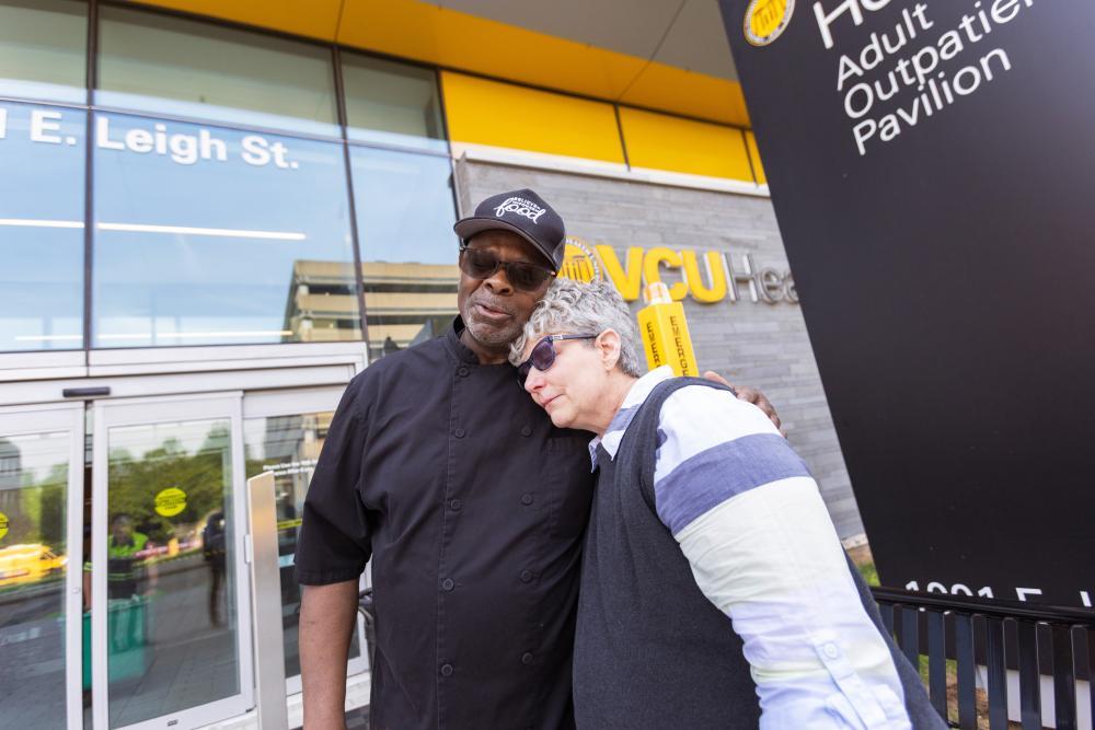 Melissa Earley hugs Lilton  Sykes, a chef with VCU  Dining Services, whom she  met while going through  cancer treatment. 