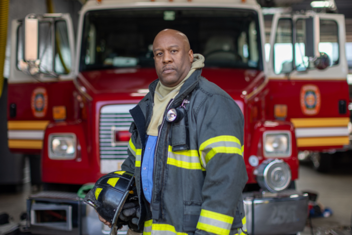 jonathan clarke, a fighter fighter standing in front of his fire truck